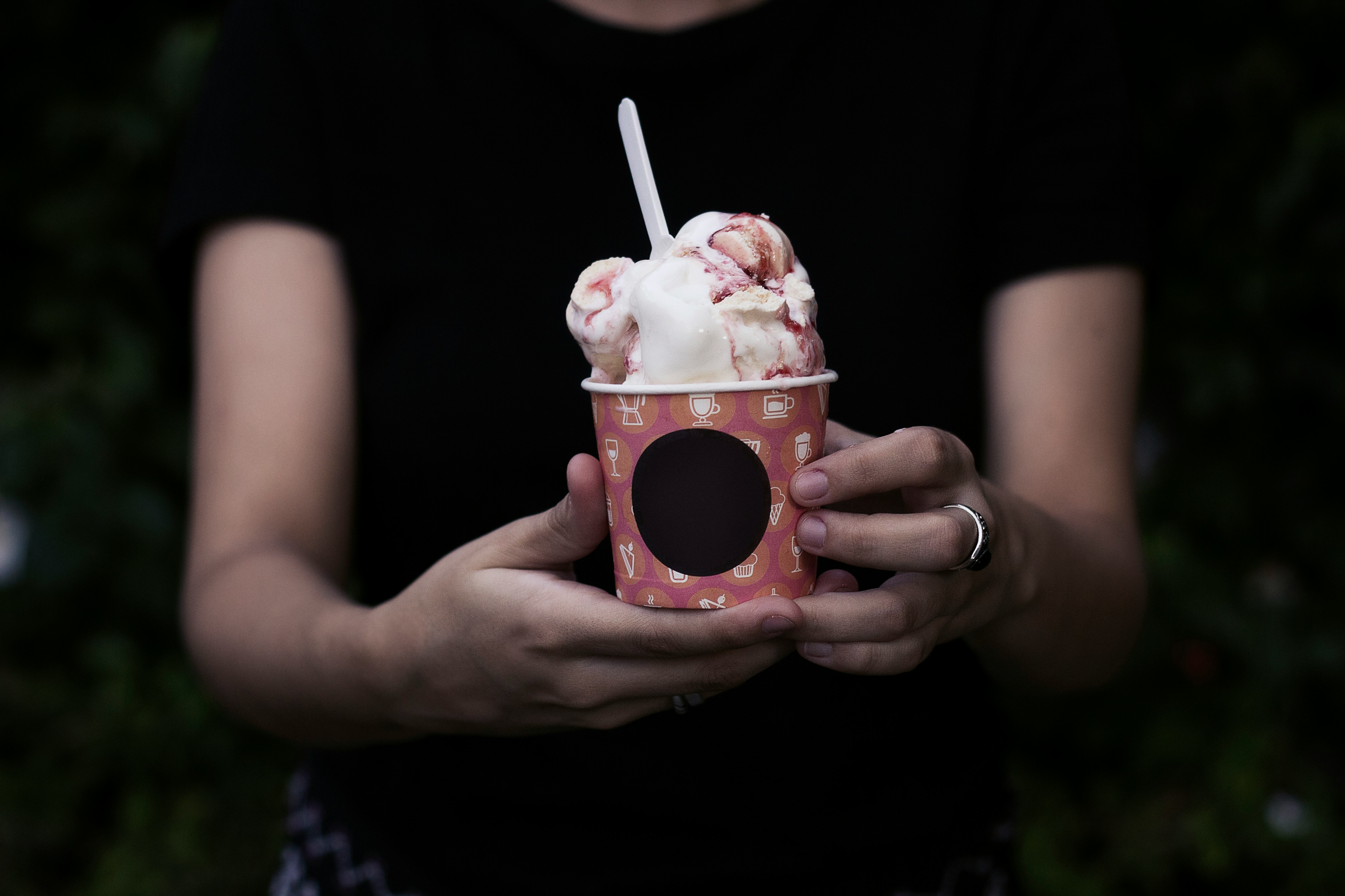 person holding bucket of ice cream